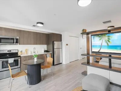 a kitchen and living room with a tv and a table at Modern Studio by Bayside & Cruise Port in Miami