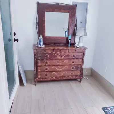 a dresser with a mirror on top of it at Quiet Studio Retreat attached to big House in Miami