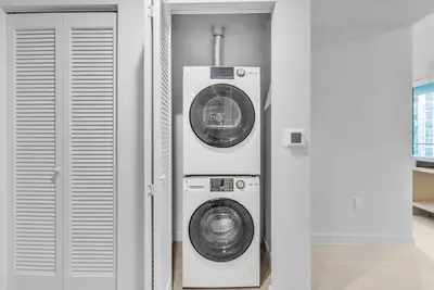 a washing machine and a dryer in a room at Chic Downtown Miami 2BR City Views Rooftop Pool in Miami