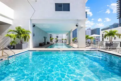 a swimming pool on the roof of a building at Brickell Condos by Vibras Concierge in Miami