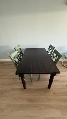 a wooden table with two chairs around it at Canal-front two-bedroom condo near Sunny Isles in North Miami Beach