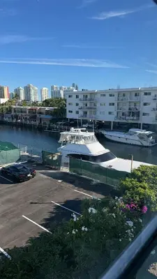 a boat docked in a marina in a city at Canal-front two-bedroom condo near Sunny Isles in North Miami Beach