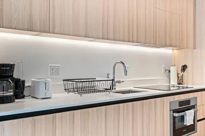a kitchen with a sink and a dish drying rack at Prime Location Condo at District 225 Downtown in Miami