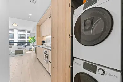 a kitchen with a microwave and a washer and dryer at Prime Location Condo at District 225 Downtown in Miami