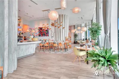 a restaurant with a bar and tables and chairs at Cozy Apartment -Balcony & Beachfront Resort in Hollywood