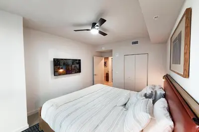 a bedroom with a bed and a ceiling fan at Stylish Condo at The Crosby in Miami