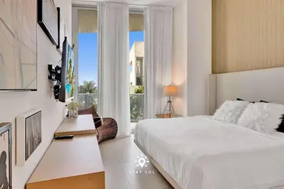 a bedroom with a bed and a large window at Beautiful Balcony 2BR Resort in Hollywood