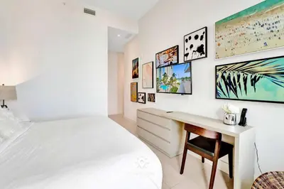 a white bedroom with a desk and a bed at Beautiful Balcony 2BR Resort in Hollywood