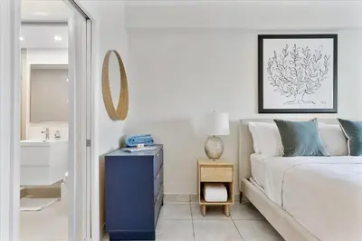 a bedroom with a bed and a sink and a mirror at Cozy Miami Beach Apartment walking distance to Beach and Ocean in Miami Beach