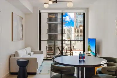 a living room with a white couch and a table at Modern and Cozy 1BD Apt with Gym & Pool in Miami