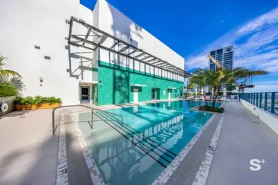 a swimming pool in front of a building at Modern and Cozy 1BD Apt with Gym & Pool in Miami