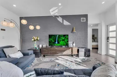 a living room with a couch and a tv at Cozy house with a pool in Miami in Miami
