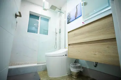 a bathroom with a shower and a toilet and a window at Las Tortugas Modern Oasis Getaway Many Amenities in Fort Lauderdale