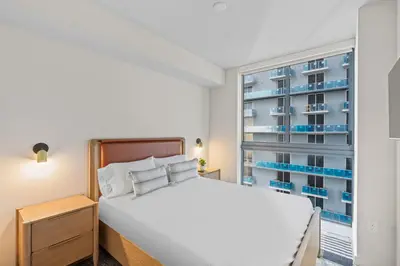a bedroom with a white bed and a window at Elegant Condo at Crosby Miami Worldcenter W Rooftop Pool & Fitness Center in Miami
