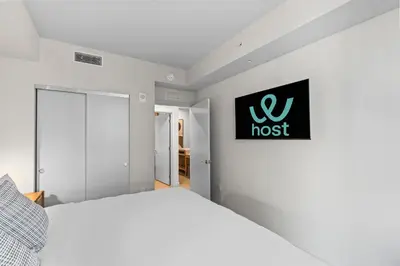 a bedroom with a white bed and a sign on the wall at Elegant Condo at Crosby Miami Worldcenter W Rooftop Pool & Fitness Center in Miami