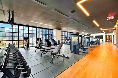 a gym with treadmills and chairs in a building at 2105 Modern studio with Balcony a Pool and a 24 hour Gym in Downtown Miami in Miami