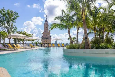 a hotel swimming pool with a clock tower in the background at 4906 Cityline Penthouse Studio with Balcony a Pool and Gym in Miami Downtown in Miami
