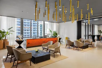 a lobby with chairs and a table and a chandelier at 4906 Cityline Penthouse Studio with Balcony a Pool and Gym in Miami Downtown in Miami