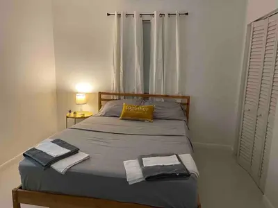 a bedroom with a bed with two towels on it at Florida Cozy Home!!! in Hallandale Beach
