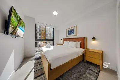 a hotel room with a bed and a tv at Spacious & Elegant 1BD Apt in Miami in Miami