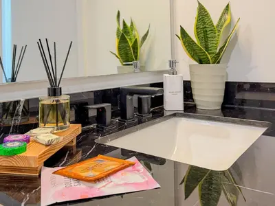 a bathroom counter with a sink and a mirror at City Skyline Views & Rooftop Pool at District 225 in Miami
