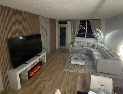 a living room with a large couch and a fireplace at Beautiful Apartment in Sunny Isles Beach in Sunny Isles Beach