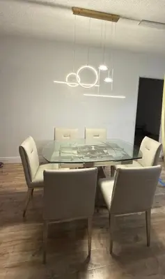 a dining room with a glass table and chairs at Beautiful Apartment in Sunny Isles Beach in Sunny Isles Beach