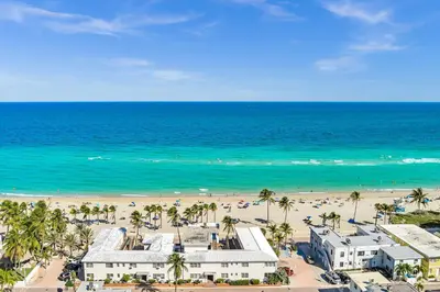 an aerial view of a beach with palm trees and buildings at Casa Pellegrino Boutique Hotel in Hollywood