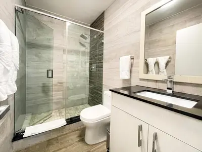 a bathroom with a shower and a toilet and a sink at Casa Pellegrino Boutique Hotel in Hollywood