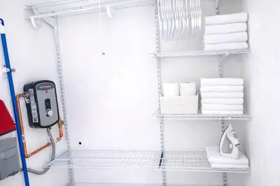a bathroom with white towels and a shelf with a phone at Villa Clara EPIC-Little Havana in Miami