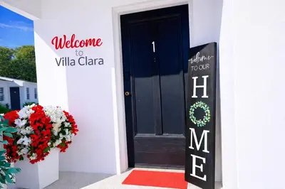 a door to a villa with a welcome sign and flowers at Villa Clara EPIC-Little Havana in Miami