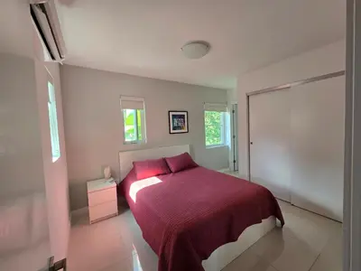 a bedroom with a bed with a red bedspread at West Ave in Miami Beach
