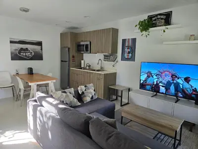 a living room with a couch and a flat screen tv at West Ave in Miami Beach