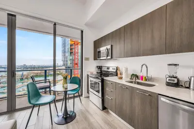 a kitchen with a table and chairs and a window at Bay Views Studio in Miami