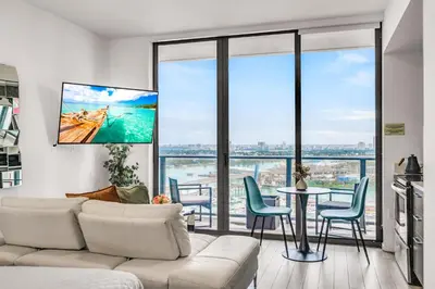 a living room with a couch and a table with chairs at Sublime Views Studio in Miami