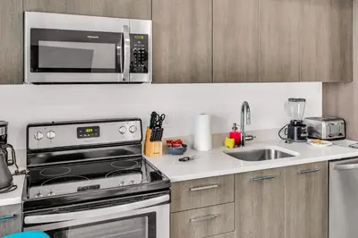 a kitchen with a stove and a microwave at Sublime Views Studio in Miami