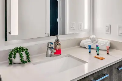 a bathroom counter with a sink and a mirror at Sublime Views Studio in Miami