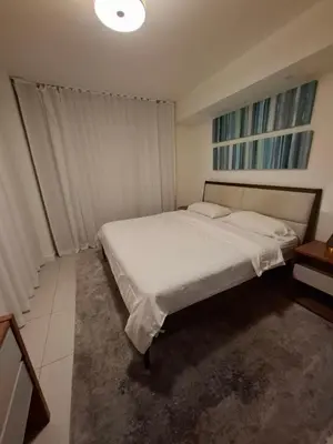 a bedroom with a large bed with white sheets at Amazing view day & night doral in Miami