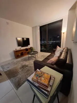 a living room with a couch and a tv at Amazing view day & night doral in Miami
