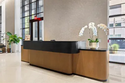 a reception desk with flowers in a lobby at 4612 High-Floor Studio w Skyline View and a 24-hour Gym in Downtown Miami in Miami