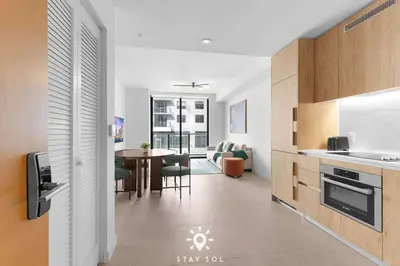 a kitchen and living room with a table and chairs at High Rise Haven with Pool Cowork & Spa in Miami in Miami