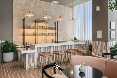 a restaurant with a bar with stools and tables at High Rise Haven with Pool Cowork & Spa in Miami in Miami