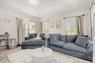 a living room with two couches and a table at Lauderdale Breeze Villas - Luxury 3 BR Coastal Retreat in Fort Lauderdale