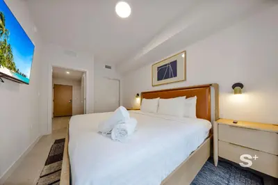 a bedroom with a large white bed with white pillows at Luxurious & Stylish 2BD Apt in Miami Gym & Pool in Miami