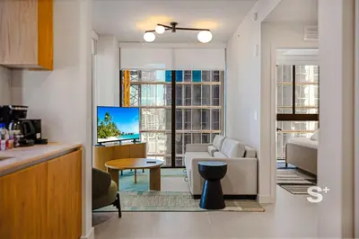 a living room with a couch and a tv in a room at Luxurious & Stylish 2BD Apt in Miami Gym & Pool in Miami