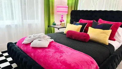 a large black bed with two pairs of shoes on it at Delano in Fort Lauderdale