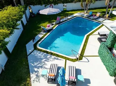 an overhead view of a swimming pool with chairs and a yard at Delano in Fort Lauderdale