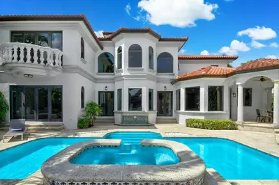 a house with a swimming pool in front of it at WATERFRONT MANSION Las Olas in Fort Lauderdale