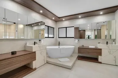 a bathroom with a large tub and two sinks and mirrors at WATERFRONT MANSION Las Olas in Fort Lauderdale