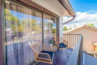 a balcony with chairs and a view of the ocean at West Kendall Retreat Everglades Miccosukee in Hammocks